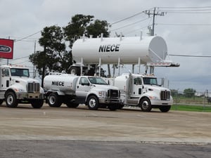 Niece water tank behind a row of Niece trucks